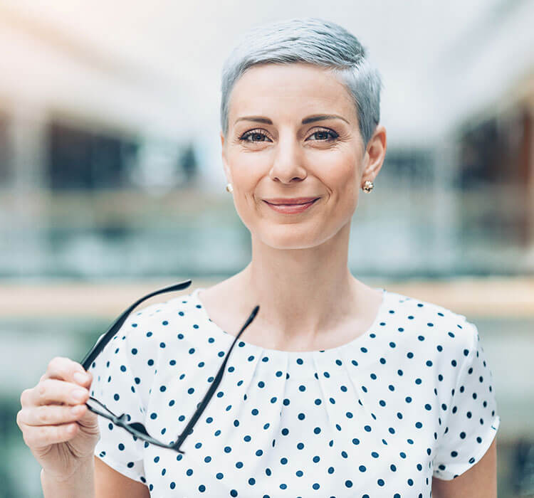 Modern businesswoman holding glasses